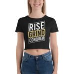 Woman wearing the Boss Babe Crop Tee with "Rise Grind Conquer" in an urban setting, exuding confidence and style.