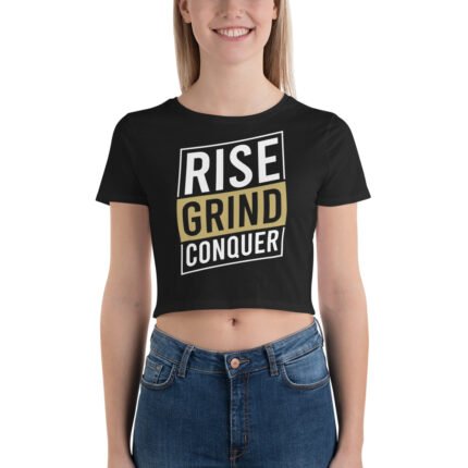 Woman wearing the Boss Babe Crop Tee with "Rise Grind Conquer" in an urban setting, exuding confidence and style.